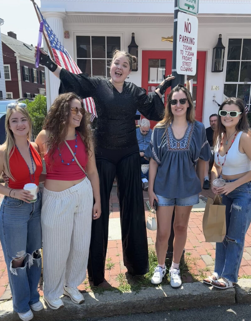 Alexis wearing all black on stilts